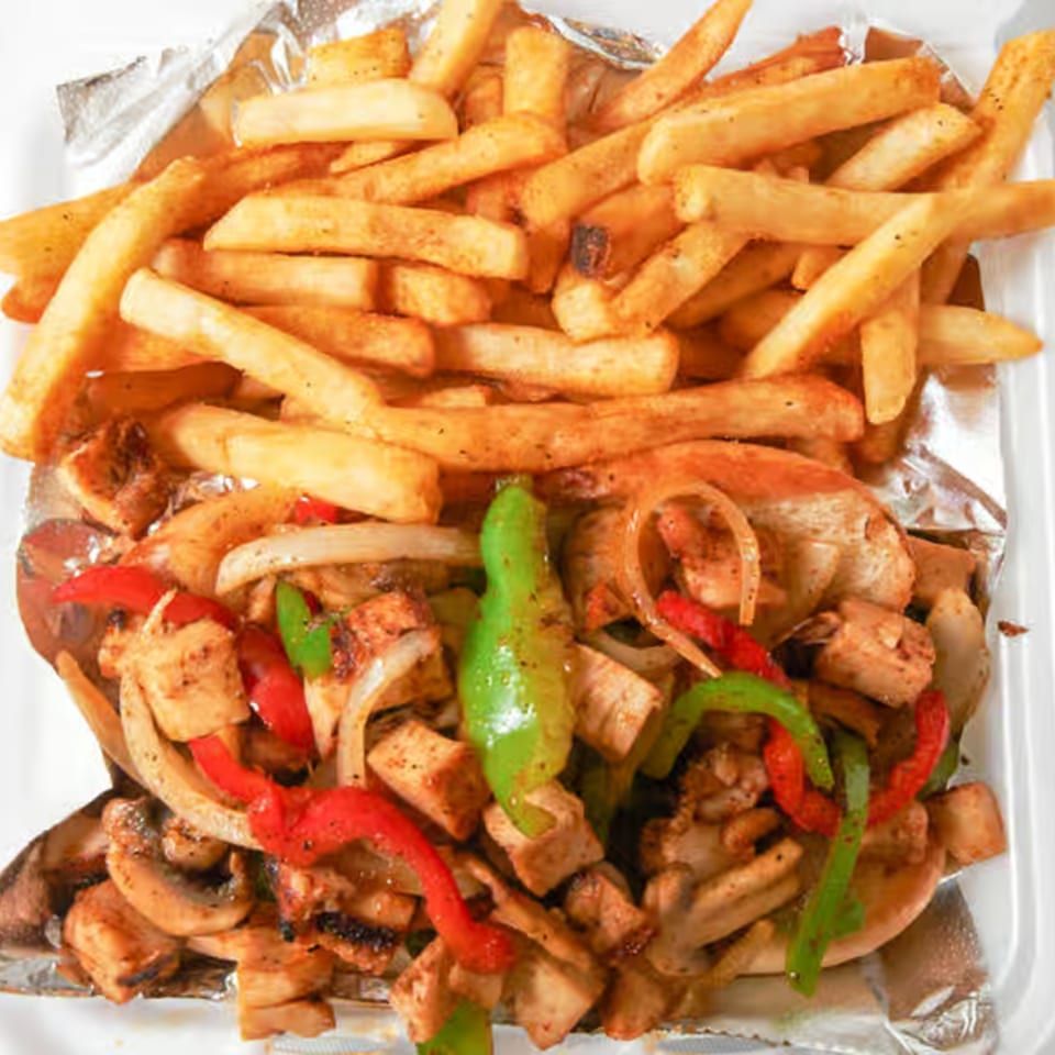 Dale's Deli chicken cheesesteak with sauteed onions, peppers, mushrooms, and a side of fries.